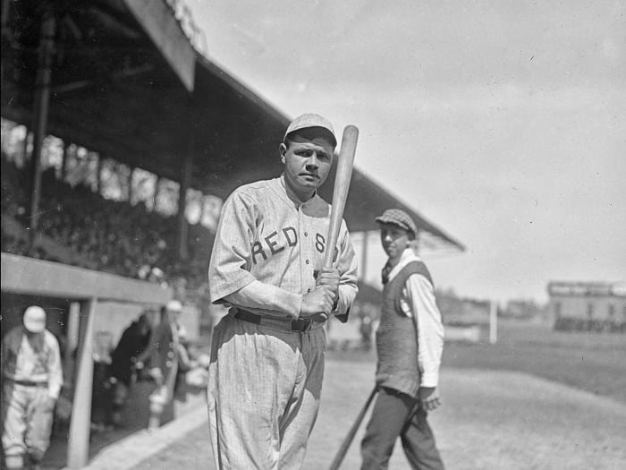 Red Sox hitter Babe Ruth holds a bat.
